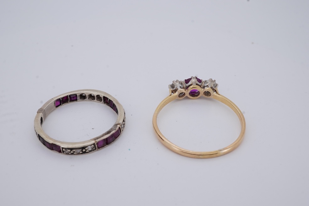 A yellow metal, stamped 18ct, ruby and diamond set three stone ring, size W, together with a yellow metal ruby and diamond set full eternity ring, size Q, gross weight 4.4 grams. Condition - poor to fair